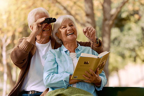Couple reading and bird watching thanks to ReSTOR IOL